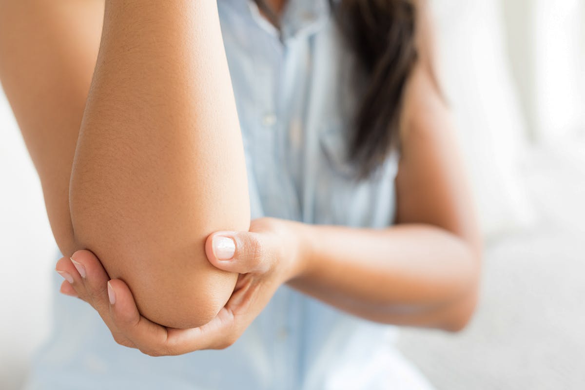 CausesofArthritis_Teaser.jpg Woman holding elbow