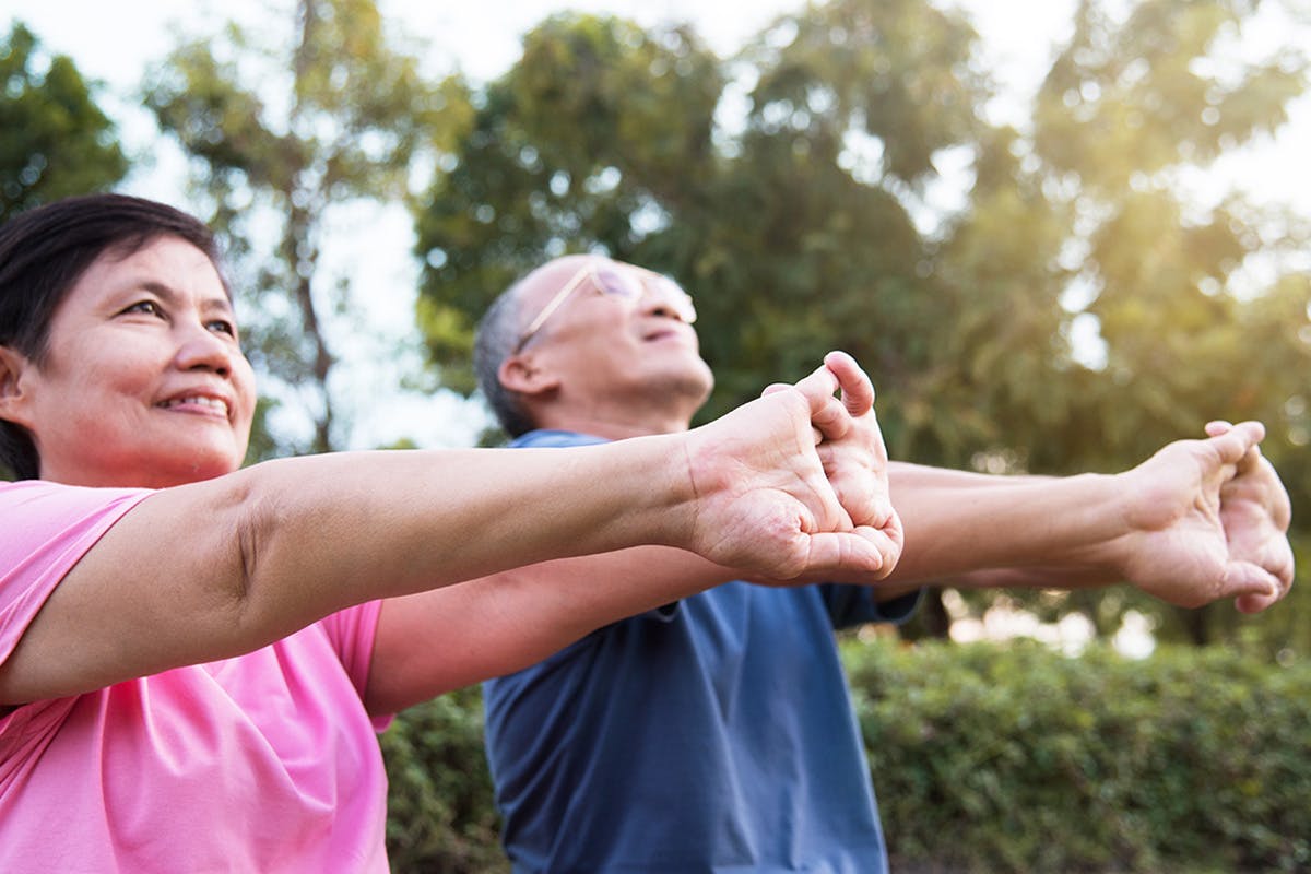 Woman and man stretching clasped hand forward