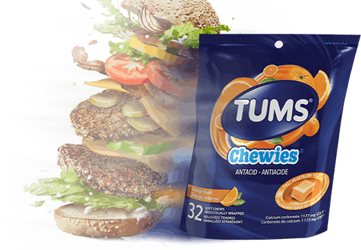 Double stacked cheeseburger next to a bag of TUMS Chewies Double stacked cheeseburger next to a bag of TUMS Chewies