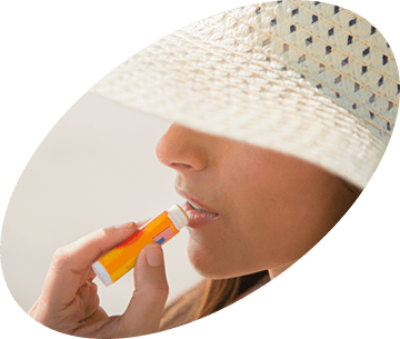 Woman applying lip balm Woman applying lip balm