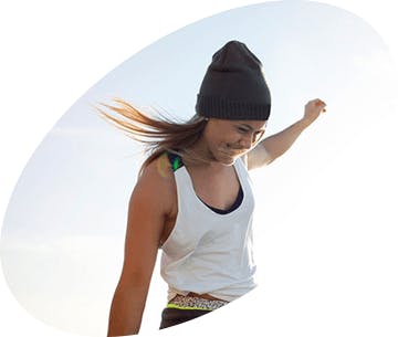 Woman standing at the beach with wind in her hair Woman standing at the beach with wind in her hair
