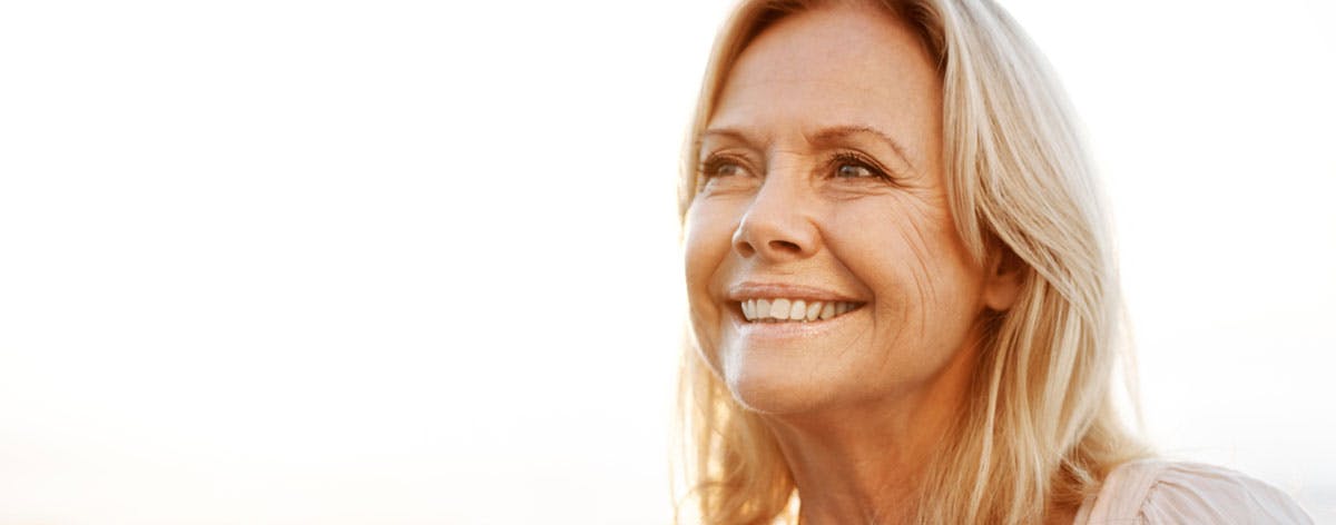 Woman drinking coffee and looking off into the distance Woman drinking coffee and looking off into the distance