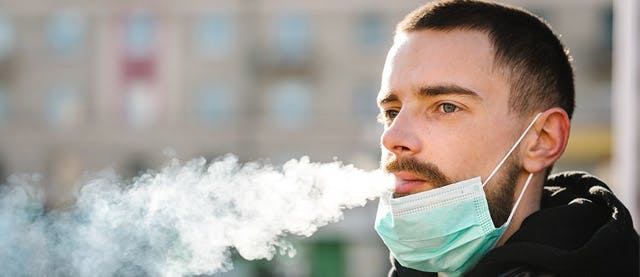 man with mask blowing smoke man with mask blowing smoke
